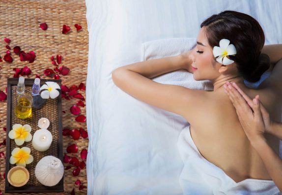 The girl relaxes in the spa salon with hand massage The girl relaxes in the spa salon with hand massage